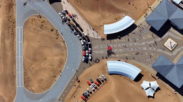 (261017) -- ZHONGWEI, Oct. 17, 2026 (Xinhua) -- An aerial drone photo taken on Oct. 17, 2026 shows vehicles gathering at the Shapotou scenic area in Zhongwei, northwest China's Ningxia Hui Autonomous Region. Marking the beginning of a desert self-driving event, a ceremony was held here on Saturday, gathering more than 500 vehicles for self-driving tours and over 1,000 tourists. (Xinhua/Wang Peng)