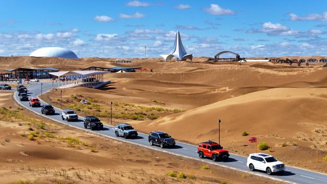 (261017) -- ZHONGWEI, Oct. 17, 2026 (Xinhua) -- An aerial drone photo taken on Oct. 17, 2026 shows vehicles driving at the Shapotou scenic area in Zhongwei, northwest China's Ningxia Hui Autonomous Region. Marking the beginning of a desert self-driving event, a ceremony was held here on Saturday, gathering more than 500 vehicles for self-driving tours and over 1,000 tourists. (Xinhua/Wang Peng)