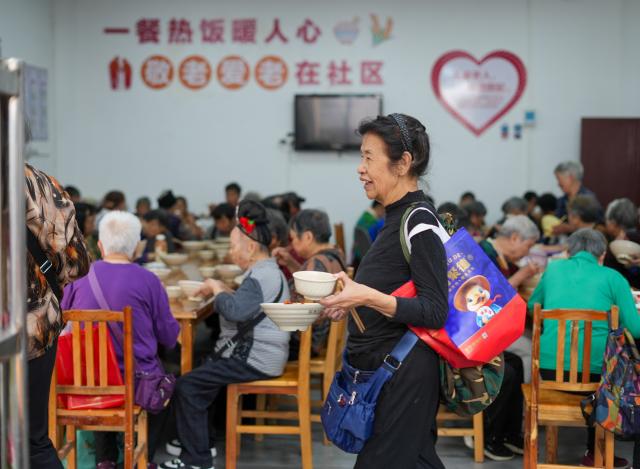 (261017) -- GUIYANG, Oct. 17, 2026 (Xinhua) -- The elderly dine at a community canteen of Ximen Street in Kaili City, southwest China's Guizhou Province, Oct. 17, 2026. In recent years, Guizhou has been continuously improving its elderly care service system, with many places upgrading community-based elderly care service stations to provide heartwarming services such as community meal aid, free health consultations, and cultural and recreational activities. (Photo by Cai Xingwen/Xinhua)
