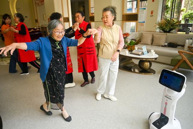(261017) -- GUIYANG, Oct. 17, 2026 (Xinhua) -- The elderly dance at a senior care facility in Wudang District of Guiyang, southwest China's Guizhou Province, Oct. 16, 2026. In recent years, Guizhou has been continuously improving its elderly care service system, with many places upgrading community-based elderly care service stations to provide heartwarming services such as community meal aid, free health consultations, and cultural and recreational activities. (Photo by Yuan Fuhong/Xinhua)