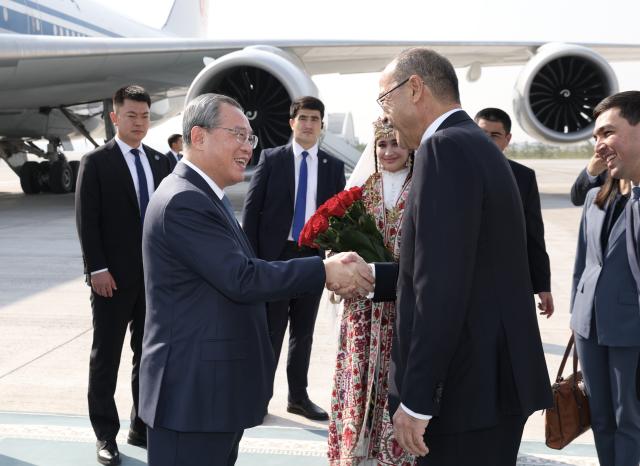 (261017) -- TASHKENT, Oct. 17, 2026 (Xinhua) -- Chinese Premier Li Qiang arrives at the airport for an official visit to Uzbekistan at the invitation of Uzbek Prime Minister Abdulla Aripov, in Tashkent, Uzbekistan, Oct. 17, 2026. On Li's arrival, the Uzbek prime minister and other senior government officials greeted him at the airport and held a welcome ceremony in his honor. (Xinhua/Huang Jingwen)