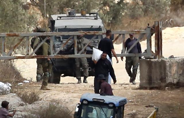 (261017) -- NABLUS, Oct. 17, 2026 (Xinhua) -- Palestinian farmers are seen at an Israeli military checkpoint after the forces prevented them from harvesting olives at their lands, in the village of Salem, east of Nablus, in the West Bank, on Oct. 17, 2026. (Photo by Nidal Eshtayeh/Xinhua)