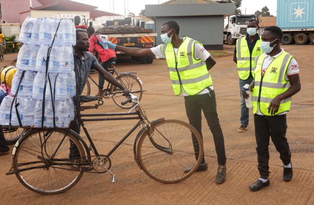 (261017) -- NAIROBI, Oct. 17, 2026 (Xinhua) -- Health officials monitor the body temperatures of a man entering Kenya at the One-Stop Border Post in Busia, Kenya, Oct. 16, 2026. Kenya's Ministry of Health on Saturday confirmed four new cases of Ebola Bundibugyo virus disease, bringing the total number of cases to seven, as efforts to prevent community transmission of the disease gathered pace. Kenya has stepped up Ebola screening and control measures at its border crossings. (Photo by John Okoyo/Xinhua)
