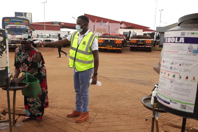 (261017) -- NAIROBI, Oct. 17, 2026 (Xinhua) -- A Health official monitors the body temperatures of a lady entering Kenya at the One-Stop Border Post in Busia, Kenya, Oct. 16, 2026. Kenya's Ministry of Health on Saturday confirmed four new cases of Ebola Bundibugyo virus disease, bringing the total number of cases to seven, as efforts to prevent community transmission of the disease gathered pace. Kenya has stepped up Ebola screening and control measures at its border crossings. (Photo by John Okoyo/Xinhua)