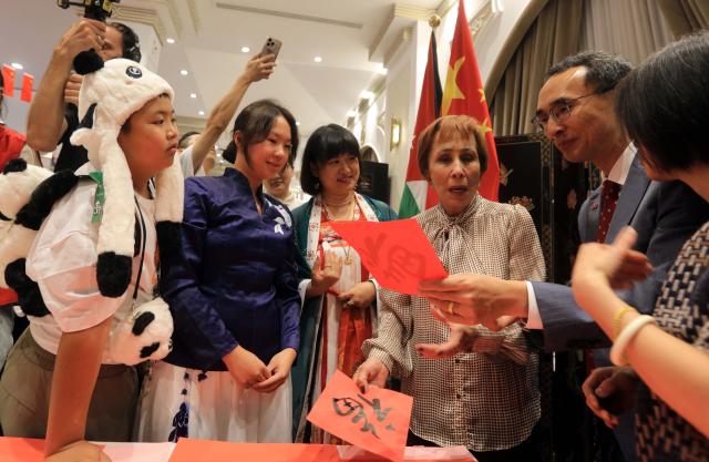 (261017) -- AMMAN, Oct. 17, 2026 (Xinhua) -- Jordanian Princess Basma bint Talal (3rd, R) tours the Chinese Embassy's pavilions during the 62nd Annual International Diplomatic Bazaar in Amman, Jordan, Oct. 17, 2026. The Chinese Embassy's pavilions at the 62nd Annual International Diplomatic Bazaar in Amman drew crowds of visitors on Saturday, offering a taste of Chinese culture through traditional food, handicrafts and other cultural products. (Photo by Mohammad Abu Ghosh/Xinhua)