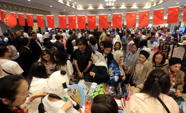 (261017) -- AMMAN, Oct. 17, 2026 (Xinhua) -- Visitors browse the Chinese Embassy's pavilions during the 62nd Annual International Diplomatic Bazaar in Amman, Jordan, Oct. 17, 2026. The Chinese Embassy's pavilions at the 62nd Annual International Diplomatic Bazaar in Amman drew crowds of visitors on Saturday, offering a taste of Chinese culture through traditional food, handicrafts and other cultural products. (Photo by Mohammad Abu Ghosh/Xinhua)