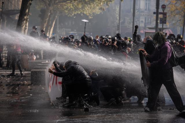 (261017) -- PARIS, Oct. 17, 2026 (Xinhua) -- Demonstrators face off with law enforcement officers during a protest in Paris, France, Oct. 17, 2026. French Interior Minister Laurent Nunez said Saturday that about 550,000 people took part in the protests across France. According to French media reports, the demonstrations brought together farmers, climate activists, trade unions and students, expressing demands on fuel prices, the cost of living, education and public services. (Photo by Aurelien Morissard/Xinhua)