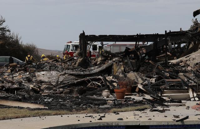 (261018) -- CALIFORNIA, Oct. 18, 2026 (Xinhua) -- A fire engine and a group of firefighters are seen next to a totally destroyed house by the Norte Fire on Avenida Calita, San Juan Capistrano, Orange County, California, the United States, on Oct. 17, 2026. Firefighters are battling multiple wildfires across Southern California on Saturday as red flag warnings remain in effect amid critical fire weather conditions. (Photo by Qiu Chen/Xinhua)