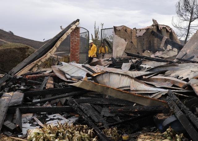 (261018) -- CALIFORNIA, Oct. 18, 2026 (Xinhua) -- Firefighters inspect a property burned by the Norte Fire on Avenida Calita, San Juan Capistrano, Orange County, California, the United States, on Oct. 17, 2026. Firefighters are battling multiple wildfires across Southern California on Saturday as red flag warnings remain in effect amid critical fire weather conditions. (Photo by Qiu Chen/Xinhua)