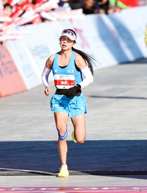 (261018) -- BEIJING, Oct. 18, 2026 (Xinhua) -- Lu Ying of China sprints to the finish line to win the third place of the women's marathon event at the 2026 Beijing Marathon & National Marathon Championships in Beijing, capital of China, Oct. 18, 2026. (Xinhua/Luo Yuan)