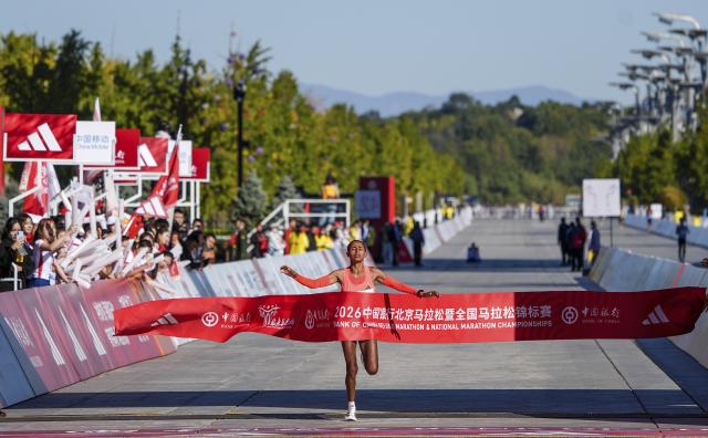 (261018) -- BEIJING, Oct. 18, 2026 (Xinhua) -- Anchinalu Dessie Genaneh of Ethiopia crosses the finish line to win the first place of the women's marathon event at the 2026 Beijing Marathon & National Marathon Championships in Beijing, capital of China, Oct. 18, 2026. (Xinhua/Ma Xiaodong)