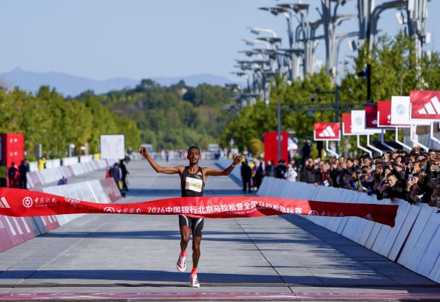 (261018) -- BEIJING, Oct. 18, 2026 (Xinhua) -- Tamirat Tola of Ethiopia crosses the finish line to win the first place of the men's marathon event at the 2026 Beijing Marathon & National Marathon Championships in Beijing, capital of China, Oct. 18, 2026. (Xinhua/Ma Xiaodong)