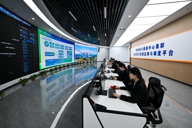 (261018) -- HOHHOT, Oct. 18, 2026 (Xinhua) -- Staff members operate the multi-cloud computing power resource monitoring and scheduling platform of Horinger data center cluster to monitor in real time and dynamically schedule computing power resources, at a talent and innovation valley in the Horinger New Area of Hohhot, north China's Inner Mongolia Autonomous Region, June 4, 2026. (Xinhua/Li Zhipeng)