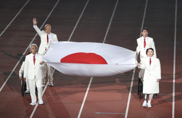 (261018) -- NAGOYA, Oct. 18, 2026 (Xinhua) -- The Japanese national flag is carried during the opening ceremony of the Aichi-Nagoya Asian Para Games in Nagoya, Japan, Oct. 18, 2026. (Xinhua/Yao Qilin)