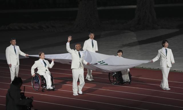 (261018) -- NAGOYA, Oct. 18, 2026 (Xinhua) -- The flag of the Asian Paralympic Committee is carried during the opening ceremony of the Aichi-Nagoya Asian Para Games in Nagoya, Japan, Oct. 18, 2026. (Xinhua/Cai Yang)