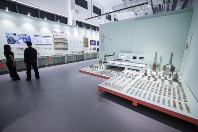 (261018) -- HANGZHOU, Oct. 18, 2026 (Xinhua) -- Visitors view exhibits at a special exhibition on innovative design of Chinese cultural heritage in Hangzhou, east China's Zhejiang Province, Oct. 18, 2026. This design exhibition is one of the side events for the fourth Liangzhu Forum. (Xinhua/Xu Yu)