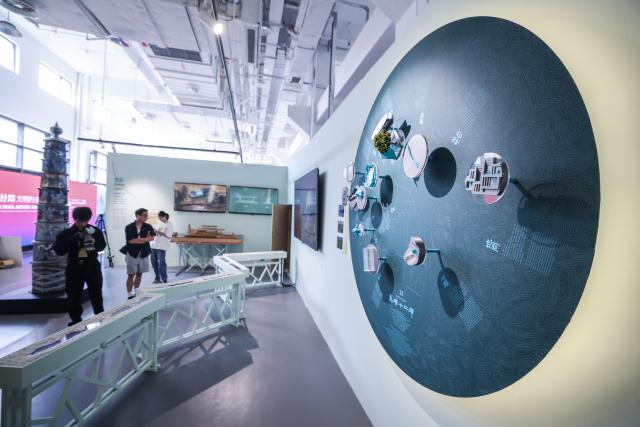 (261018) -- HANGZHOU, Oct. 18, 2026 (Xinhua) -- Visitors view exhibits at a special exhibition on innovative design of Chinese cultural heritage in Hangzhou, east China's Zhejiang Province, Oct. 18, 2026. This design exhibition is one of the side events for the fourth Liangzhu Forum. (Xinhua/Xu Yu)