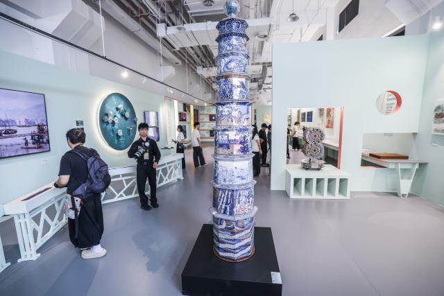 (261018) -- HANGZHOU, Oct. 18, 2026 (Xinhua) -- Visitors view exhibits at a special exhibition on innovative design of Chinese cultural heritage in Hangzhou, east China's Zhejiang Province, Oct. 18, 2026. This design exhibition is one of the side events for the fourth Liangzhu Forum. (Xinhua/Xu Yu)