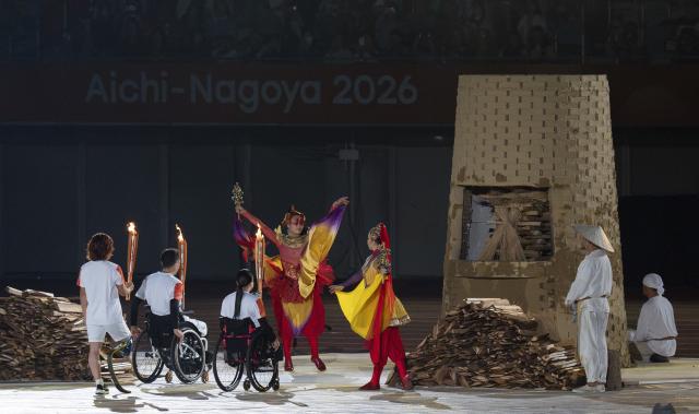 (261018) -- NAGOYA, Oct. 18, 2026 (Xinhua) -- Torch bearers relay the torch during the opening ceremony of the Aichi-Nagoya Asian Para Games in Nagoya, Japan, Oct. 18, 2026. (Xinhua/Cai Yang)