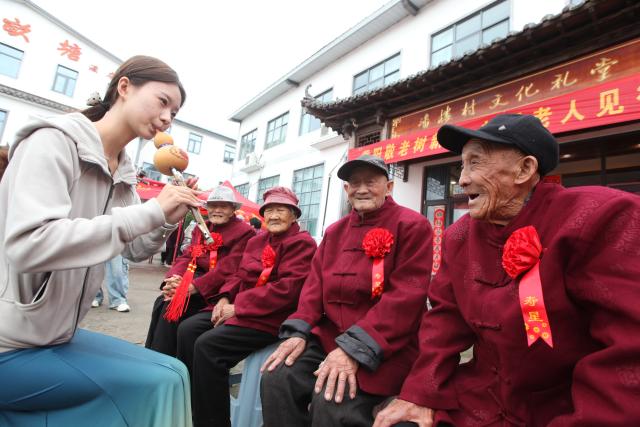 (261018) -- BEIJING, Oct. 18, 2026 (Xinhua) -- A volunteer plays music for senior citizens during an event marking the Chongyang Festival in Xuzhou, east China's Jiangsu Province, Oct. 18, 2026. A series of celebration activities were held across the country to mark the Chongyang Festival, which falls on Oct. 18 this year. Also known as China's Seniors' Day, it honors the country's traditional virtues of filial piety and family love. (Photo by Kuai Chuang/Xinhua)