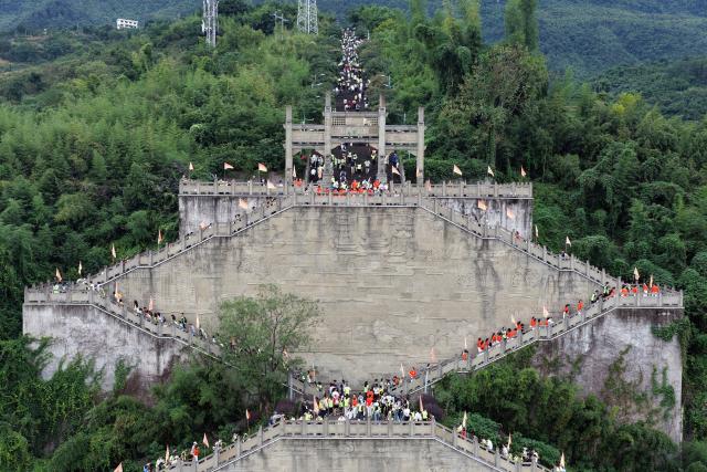 (261018) -- BEIJING, Oct. 18, 2026 (Xinhua) -- This aerial drone photo taken on Oct. 18, 2026 shows people attending a hiking event marking the Chongyang Festival in southwest China's Chongqing. A series of celebration activities were held across the country to mark the Chongyang Festival, which falls on Oct. 18 this year. Also known as China's Seniors' Day, it honors the country's traditional virtues of filial piety and family love. (Photo by Qin Tingfu/Xinhua)