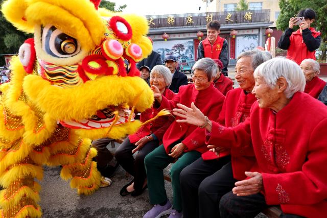 (261018) -- BEIJING, Oct. 18, 2026 (Xinhua) -- Senior citizens watch a lion dance during an event marking the Chongyang Festival in Zaozhuang, east China's Shandong Province, Oct. 18, 2026. A series of celebration activities were held across the country to mark the Chongyang Festival, which falls on Oct. 18 this year. Also known as China's Seniors' Day, it honors the country's traditional virtues of filial piety and family love. (Photo by Sun Zhongzhe/Xinhua)
