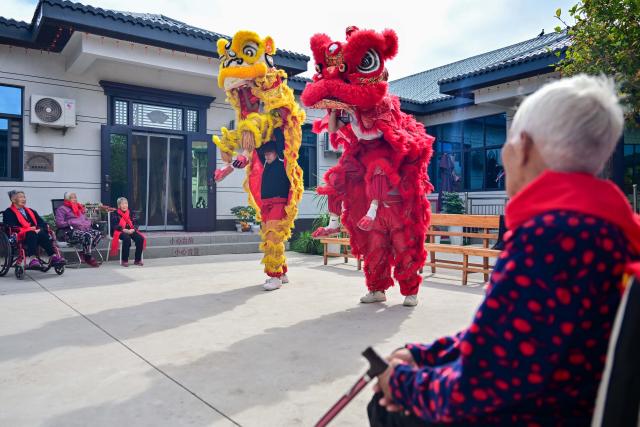 (261018) -- BEIJING, Oct. 18, 2026 (Xinhua) -- Senior citizens watch a lion dance during an event marking the Chongyang Festival in Luoyang, central China's Henan Province, Oct. 18, 2026. A series of celebration activities were held across the country to mark the Chongyang Festival, which falls on Oct. 18 this year. Also known as China's Seniors' Day, it honors the country's traditional virtues of filial piety and family love. (Photo by Li Weichao/Xinhua)
