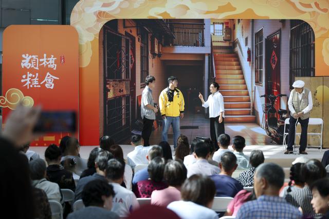(261018) -- BEIJING, Oct. 18, 2026 (Xinhua) -- People watch a performance during an event marking the Chongyang Festival in east China's Shanghai, Oct. 18, 2026. A series of celebration activities were held across the country to mark the Chongyang Festival, which falls on Oct. 18 this year. Also known as China's Seniors' Day, it honors the country's traditional virtues of filial piety and family love. (Xinhua/Wang Xiang)