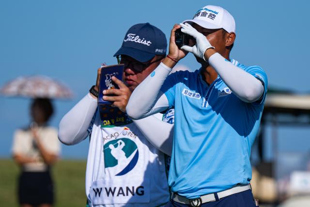 (261018) -- MACAO, Oct. 18, 2026 (Xinhua) -- Wang Wei-hsuan (R) of Chinese Taipei competes during the Macao Open golf tournament in Macao, South China, Oct. 18, 2026. (Xinhua/Cheong Kam Ka)