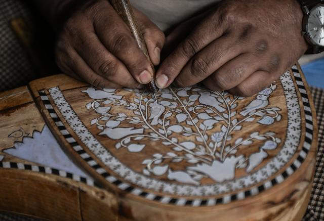 (261018) -- SRINAGAR, Oct. 18, 2026 (Xinhua) -- Altaf Ahmad Sheikh makes a sarangi, a traditional Kashmiri musical instrument, at his workshop in Srinagar city, the summer capital of Indian-controlled Kashmir, Oct. 13, 2026. TO GO WITH "Feature: Indian-controlled Kashmir's traditional musical instrument makers strive to keep vanishing craft alive" (Xinhua/Javed Dar)