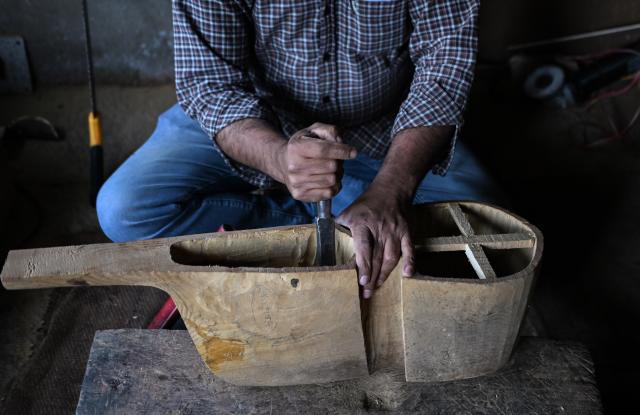 (261018) -- SRINAGAR, Oct. 18, 2026 (Xinhua) -- Mushtaq Ahmad Dar makes a rabab, a traditional Kashmiri musical instrument, at his workshop in the outskirts of Srinagar city, the summer capital of Indian-controlled Kashmir, Oct. 12, 2026. TO GO WITH "Feature: Indian-controlled Kashmir's traditional musical instrument makers strive to keep vanishing craft alive" (Xinhua/Javed Dar)