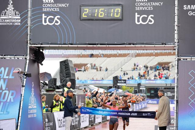 (261018) -- AMSTERDAM, Oct. 18, 2026 (Xinhua) -- Buze Diriba (C) of Ethiopia crosses the finish line during the Amsterdam Marathon in Amsterdam, the Netherlands, Oct. 18, 2026. (Photo by Sylvia Lederer/Xinhua)