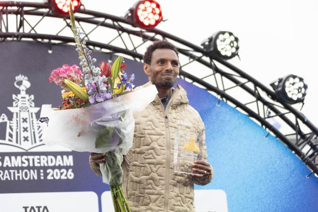 (261018) -- AMSTERDAM, Oct. 18, 2026 (Xinhua) -- Lemi Berhanu of Ethiopia displays his trophy on the awarding podium after winning the men's race of the Amsterdam Marathon in Amsterdam, the Netherlands, Oct. 18, 2026. (Photo by Sylvia Lederer/Xinhua)