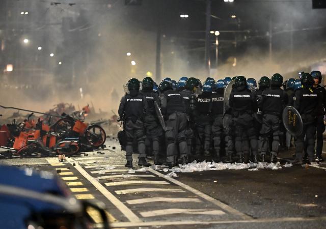 (261018) -- BOLOGNA, Oct. 18, 2026 (Xinhua) -- Photo taken on Oct. 17, 2026 shows violent clashes during protests near the central station of Bologna, Italy. Protests against the rising cost of living turned violent on Saturday in several northern Italian cities, including Milan, Bologna and Turin, leaving dozens of people injured, according to Italian media reports. (Xinhua)