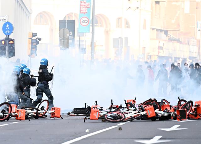 (261018) -- BOLOGNA, Oct. 18, 2026 (Xinhua) -- Photo taken on Oct. 17, 2026 shows violent clashes during protests near the central station of Bologna, Italy. Protests against the rising cost of living turned violent on Saturday in several northern Italian cities, including Milan, Bologna and Turin, leaving dozens of people injured, according to Italian media reports. (Xinhua)