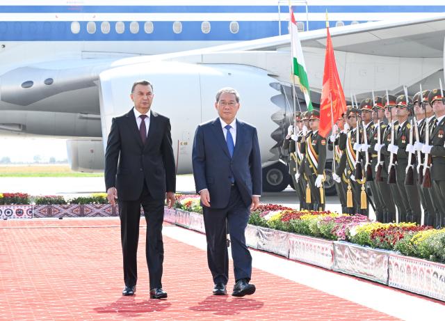 (261018) -- DUSHANBE, Oct. 18, 2026 (Xinhua) -- Chinese Premier Li Qiang, accompanied by Tajik Prime Minister Kokhir Rasulzoda, reviews the guard of honor during a welcome ceremony at the Dushanbe International Airport in Dushanbe, Tajikistan, Oct. 18, 2026. Li arrived in Dushanbe on Sunday for an official visit to Tajikistan and to attend the 25th meeting of the Council of Heads of Government (Prime Ministers) of Member States of the Shanghai Cooperation Organization (SCO) at the invitation of Rasulzoda.
   Rasulzoda and other senior government officials greeted Li at the airport, and a welcome ceremony was held in his honor. (Xinhua/Shen Hong)