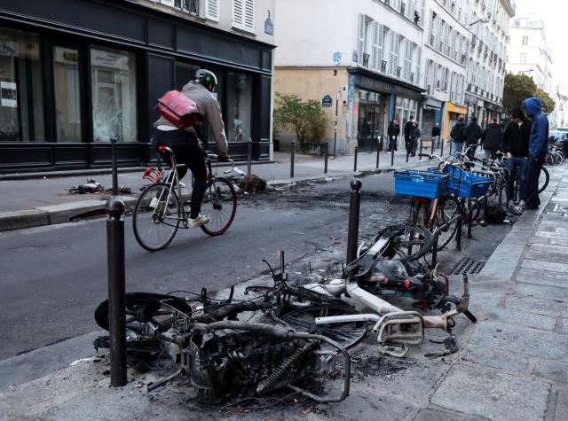(261018) -- PARIS, Oct. 18, 2026 (Xinhua) -- Bicycles destroyed by fire during a protest are seen on a street in Paris, France, Oct. 18, 2026. French President Emmanuel Macron on Sunday vowed legal action against those responsible for violence during protests across the country on Saturday. (Xinhua/Wu Huiwo)