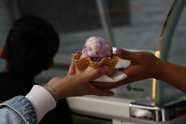 (261018) -- MEXICO CITY, Oct. 18, 2026 (Xinhua) -- A woman receives a Catrina-shaped ice cream in Mexico City, capital of Mexico, Oct. 17, 2026. As the Day of the Dead approaches, an ice cream shop in Mexico City has introduced Catrina-shaped ice creams, attracting many local residents and tourists. (Photo by Francisco Canedo/Xinhua)