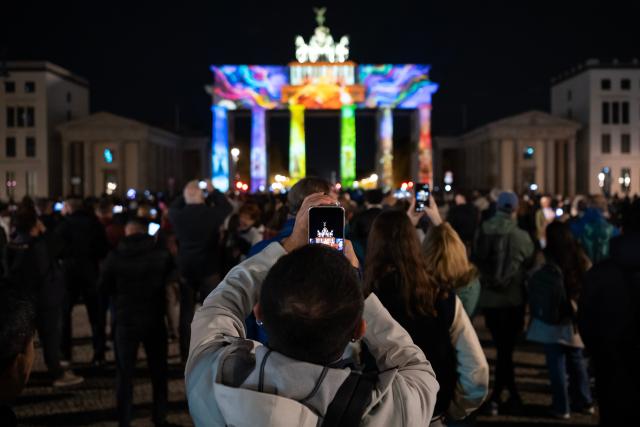 (261019) -- BERLIN, Oct. 19, 2026 (Xinhua) -- People enjoy a light show during the 2026 Festival of Lights at Brandenburg Gate in Berlin, Germany, Oct. 18, 2026. The festival was held here from Oct. 9 to 18. (Xinhua/Zhang Haofu)