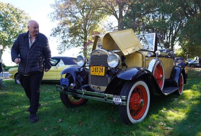 (261019) -- NEW YORK, Oct. 19, 2026 (Xinhua) -- A man views an exhibit during a vintage car show at Fort Totten in New York, the United States, Oct. 18, 2026. An annual vintage car show to greet autumn was held here on Sunday. (Xinhua/Zhang Fengguo)