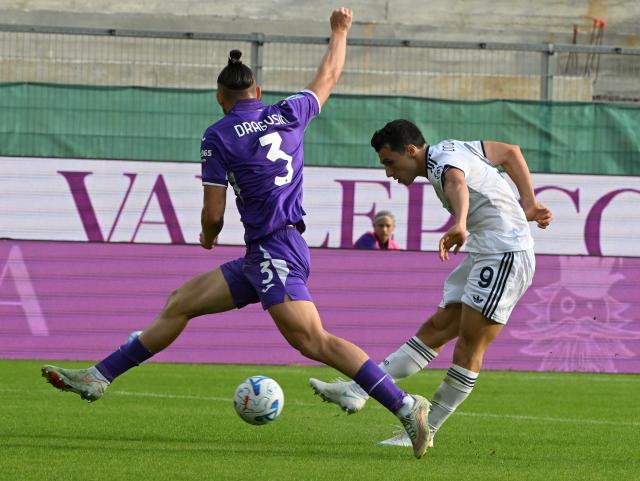 (261019) -- FLORENCE, Oct. 19, 2026 (Xinhua) -- Como's Tasos Douvikas (R) shoots to score during a Serie A football match between Como and Fiorentina in Florence, Italy, Oct. 18, 2026. (Photo by Alberto Lingria/Xinhua)