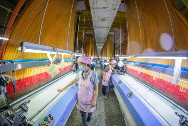 (261019) -- BEIJING, Oct. 19, 2026 (Xinhua) -- Workers operate on the production lines at a workshop of a textile company in Nantong, east China's Jiangsu Province, Oct. 19, 2026. China's gross domestic product (GDP) grew 4.5 percent year on year in the third quarter (Q3) of 2026, data from the National Bureau of Statistics (NBS) showed Monday.
  The country's economy expanded 4.6 percent year on year in the first three quarters.
  The world's second-largest economy generated about 107.11 trillion yuan (about 15.94 trillion U.S. dollars) in output during the January-September period, according to the NBS. (Photo by Zhai Huiyong/Xinhua)
