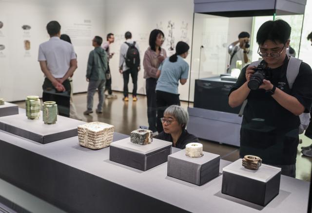 (261019) -- HANGZHOU, Oct. 19, 2026 (Xinhua) -- People visit a special exhibition marking the 90th anniversary of the discovery of the Liangzhu archaeological site in Hangzhou, east China's Zhejiang Province, Oct. 18, 2026. The year 2026 marks the 90th anniversary of the discovery of the Liangzhu ruins. The fourth Liangzhu Forum, which opened Sunday in Hangzhou, has rolled out a series of concurrent cultural events including a sub-forum, a themed special exhibition and a tour in the Archaeological Ruins of Liangzhu City Park. (Xinhua/Xu Yu)
