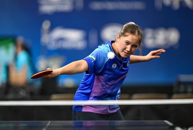 (261019) -- TASHKENT, Oct. 19, 2026 (Xinhua) -- Asel Erkebaeva of Uzbekistan hits a return to Huang Cheong Leng of China's Macao during the women's team group match between China's Macao and Uzbekistan at the 29th ITTF-Asian Table Tennis Championships in Tashkent, Uzbekistan, Oct. 19, 2026. (Xinhua/Feng Kaihua)