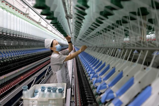 (261019) -- BEIJING, Oct. 19, 2026 (Xinhua) -- A worker operates on a yarn production line at a company in Zaozhuang, east China's Shandong Province, Oct. 19, 2026. (Photo by Sun Zhongzhe/Xinhua)
