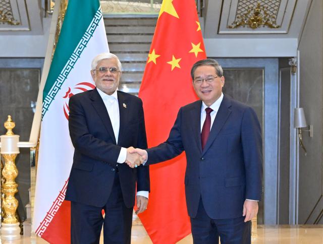 (261019) -- DUSHANBE, Oct. 19, 2026 (Xinhua) -- Chinese Premier Li Qiang meets with Iran's First Vice President Mohammad-Reza Aref on the sidelines of the 25th meeting of the Council of Heads of Government (Prime Ministers) of Member States of the Shanghai Cooperation Organization (SCO) in Dushanbe, Tajikistan, Oct. 19, 2026. (Xinhua/Shen Hong)