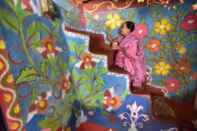 (261019) -- CHAPAINAWABGANJ, Oct. 19, 2026 (Xinhua) -- A woman paints "Alpona" in a village in Chapainawabganj District, Bangladesh, Oct. 18, 2026. "Alpona" is a traditional form of folk art practiced in South Asia and is mainly created by women in the local community. (Photo by Habibur Rahman/Xinhua)