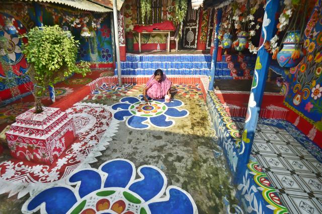 (261019) -- CHAPAINAWABGANJ, Oct. 19, 2026 (Xinhua) -- A woman paints "Alpona" in a village in Chapainawabganj District, Bangladesh, Oct. 18, 2026. "Alpona" is a traditional form of folk art practiced in South Asia and is mainly created by women in the local community. (Photo by Habibur Rahman/Xinhua)