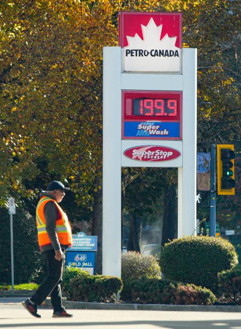 (261019) -- VANCOUVER, Oct. 19, 2026 (Xinhua) -- A gas station staff worker walks past a gas price display in Vancouver, British Columbia, Canada, on Oct. 19, 2026. Canada's Consumer Price Index (CPI) rose 3.1 percent year over year in September, following a 3-percent increase in August, Statistics Canada said Monday. (Photo by Liang Sen/Xinhua)