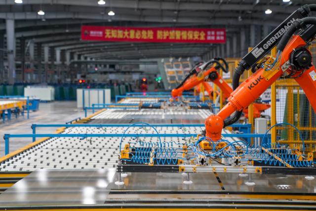 (261020) -- ZHAOTONG, Oct. 20, 2026 (Xinhua) -- This photo taken on Oct. 19, 2026 shows a photovoltaic glass manufacturing line in the workshop of Zhaotong Kibing Photovoltaic Technology Co,. Ltd. in Zhaotong City, southwest China's Yunnan Province. Leveraging its advantages in rich resources of silicon ore and the development of green electricity, Zhaotong City has attracted leading enterprises to develop the photovoltaic glass manufacturing industry, bringing about employment for surrounding residents. Currently, the city has basically formed an industrial chain from silicon mining and washing to the manufacturing of photovoltaic glass and photovoltaic modules. (Xinhua/Peng Yikai)